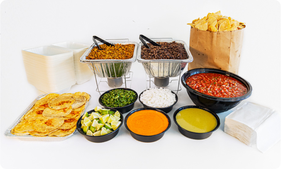 Taco bar catering setup with chips and salsa