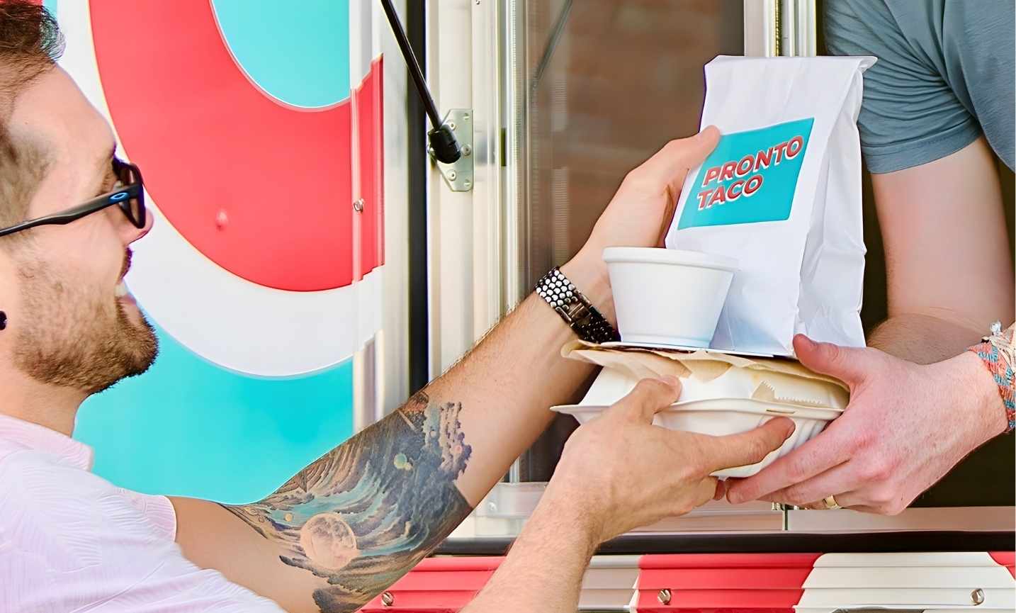 Pronto Taco serving a corporate catering order from the food truck window