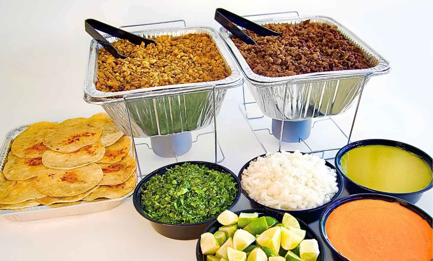 Pronto Taco taco bar catering setup with trays, tortillas, chips, and salsa