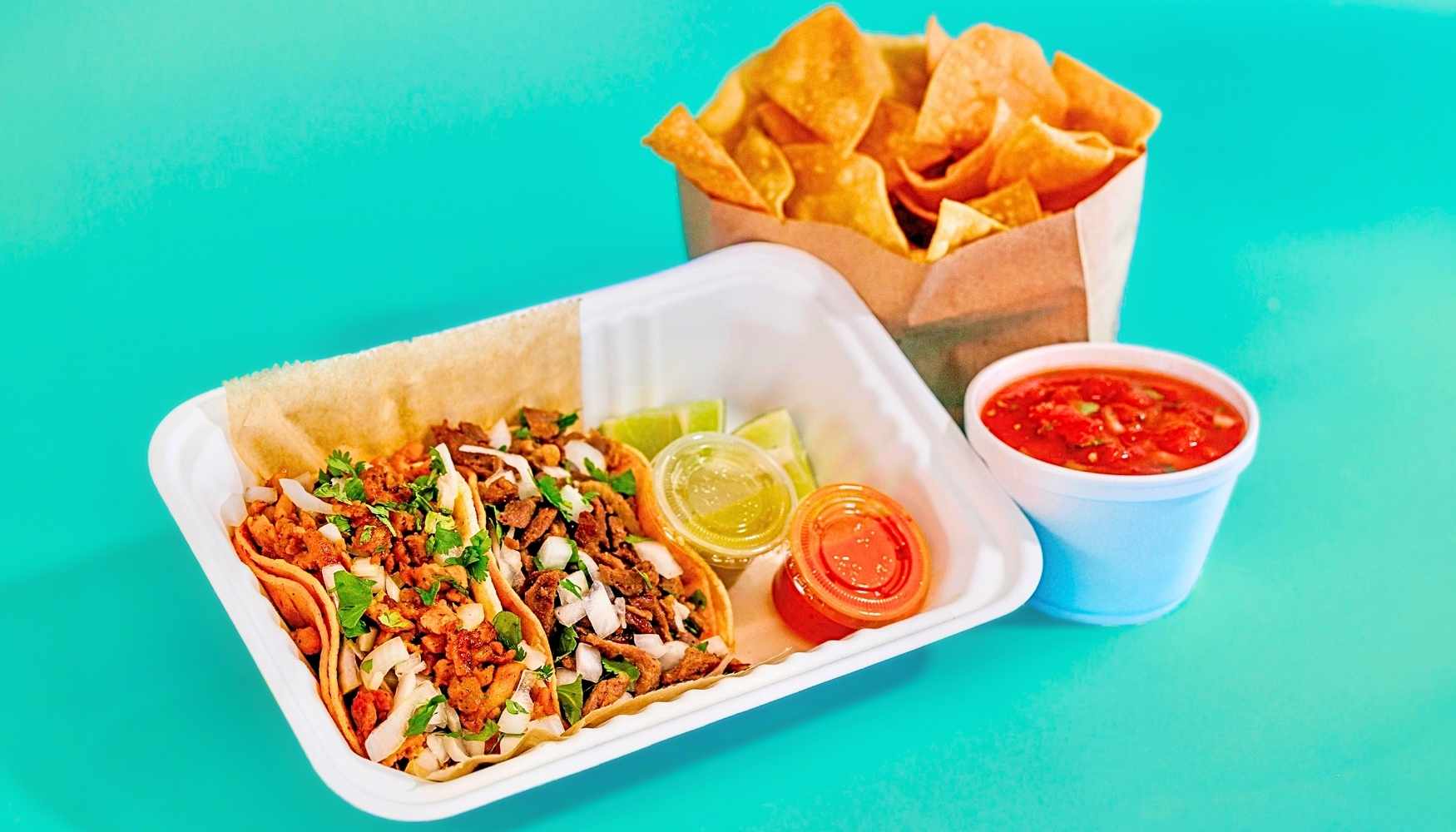 Pronto Combo with two tacos, chips, and salsa ready to serve
