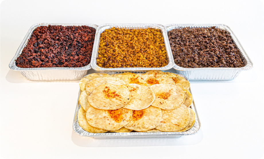 Taco meat in catering trays and tortillas in a catering tray